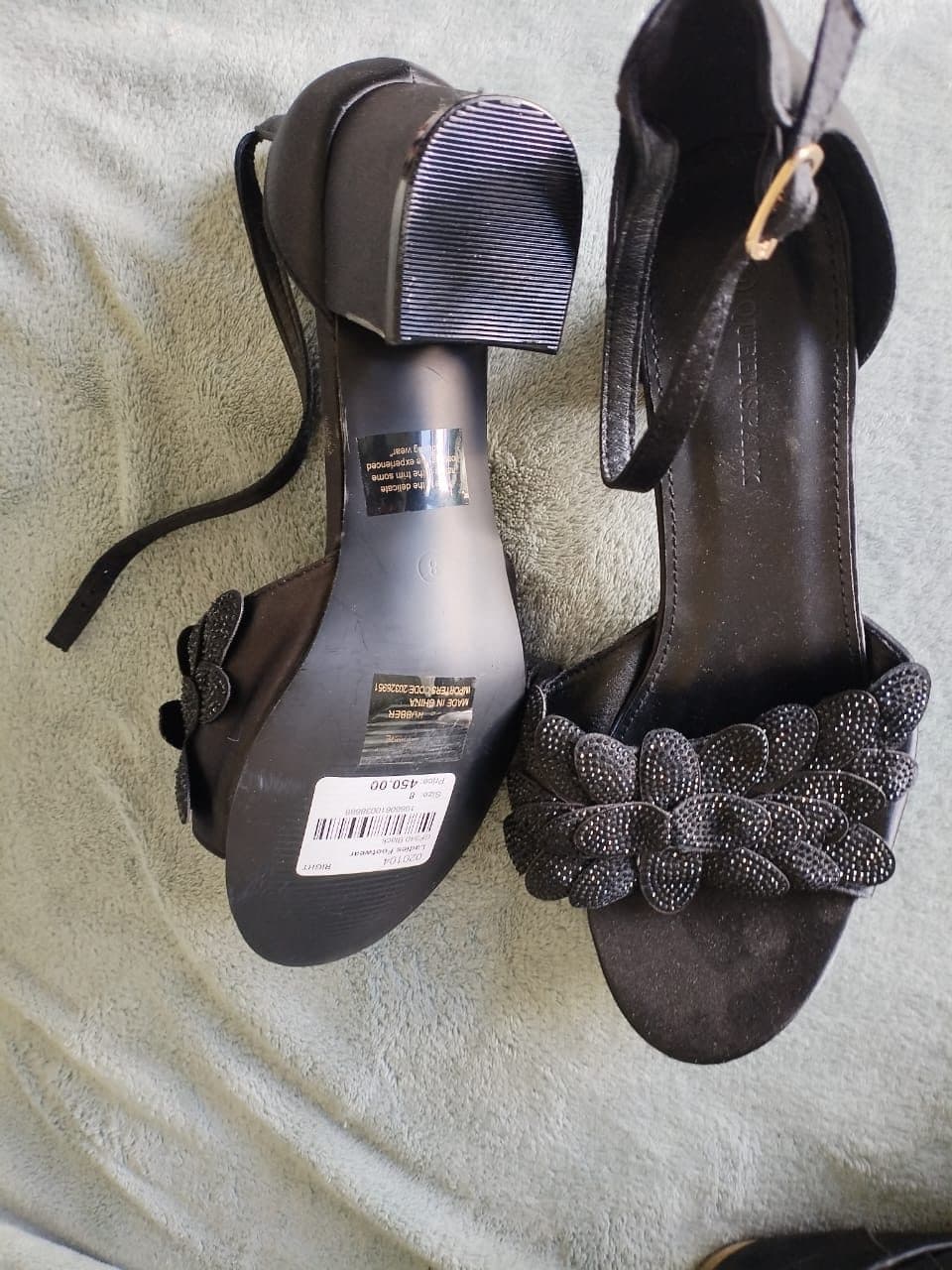Black block heel sandals with embellished petal detail